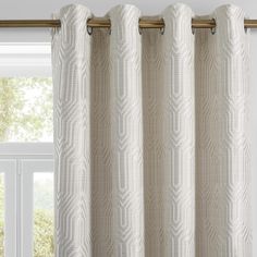 a white curtain hanging on the side of a window