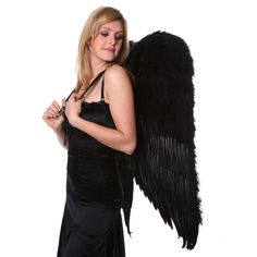 a woman in a black dress holding an angel wing