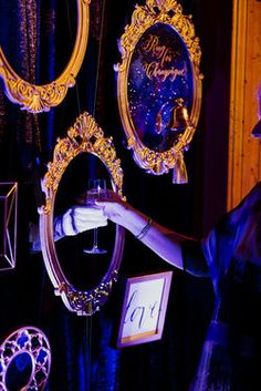 a woman standing in front of two mirrors