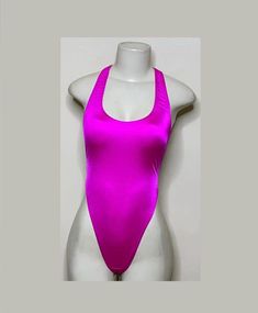 Welcome to my shop Let's Make Money Together 💕 DETAILS  * Handmade Item  * Materials: Nylon, Shiny Spandex * Full Bodysuit  * Never used  DESCRIPTION  * Thong Bodysuit  * Cerise Color Spandex * 4 way stretch Fabric * Mannequin is wearing XS/Small (may choose sizing at checkout)  SHIPPING  My current shipping turnaround is really quick 1 to 2 days  RETURNS & EXCHANGES  No refunds or exchanges if you have any issues with your purchase please feel free to reach me personally. I can accommodate on your next order of change a sizing (hopefully) we can discuss that further for a custom size as appreciation but please read standard size.  ALL bodysuit are FINAL SALE for sanitary issues. I would not be able to resell those items   Hand wash preferred or hang dry💕 Stretch T-back Bodysuit For Club, Fitted T-back Party Leotard, Stretch One-piece Leotard For Club, Stretch One-piece Club Leotard, Pink Summer Unitard, Summer Dance Bodysuit With High Stretch, Summer Dance Bodysuit With Stretch, Summer Backless Dancewear Bodysuit, Summer Backless Dancewear Leotard