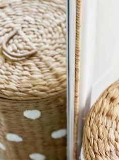 a basket sitting next to a mirror on the floor