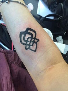 a tattoo on the arm of a person with a black and white design on it