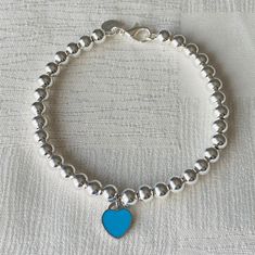 This beautiful heart charm beaded bracelet is the perfect accent to any jewelry piece. It's simplicity makes it versatile so you can wear it on any occasion!  M A T E R I A L S  ♥925 Sterling Silver ♥Silver Ball Beads  ♥Blue Enamel Heart Tag R E T U R N S  &  R E F U N D S   I gladly accept returns and exchanges ♥Contact me within: 14 days of delivery ♥Ship items back within: 21 days of delivery ♥I don't accept cancellations, but please contact me if you have any problems with your order. The fo Sterling Silver Bracelets With Heart Beads, Sterling Silver Bracelet With Heart Beads, Elegant Blue Bracelets For Valentine's Day, Valentine's Day Heart Shaped Sterling Silver Beaded Bracelets, Silver Heart-shaped Beaded Bracelets, Silver Beaded Bracelets With Heart Charm In Sterling Silver, Silver Heart-shaped Sterling Beaded Bracelets, Blue Bracelets With Heart Charm Gift, Blue Heart Charm Bracelets As Gifts