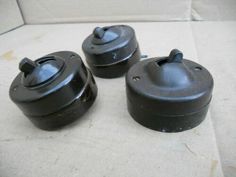 three black pots sitting on top of a table