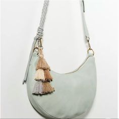 Designed In A Stylish Half-Moon Silhouette, This Crossbody Bag Is Sized To Fit All Of Your Essentials With Hands-Free Ease. Polyurethane; Polyester Lining Polyester Tassel Embellishments One Inner Zip, Two Inner Slip Pockets One Outer Zip Pocket Zip Closure Imported Dimensions 7.5"H, 13.5"W, 4"D 23" Strap Drop Brand New Without Tags Chic Tassel Crossbody Shoulder Bag, Chic Crossbody Shoulder Bag With Tassels, Everyday Tassels Crossbody Shoulder Bag, Crossbody Hobo Bag With Tassels, Daily Use Crossbody Hobo Bag With Tassels, Blue Everyday Bag With Tassels, Blue Bag With Tassels For Everyday Use, Blue Shoulder Bag With Tassels For Daily Use, Blue Shoulder Bag With Tassels For Everyday Use