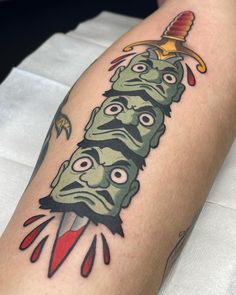 a person with a tattoo on their leg that has an image of a zombie holding a knife