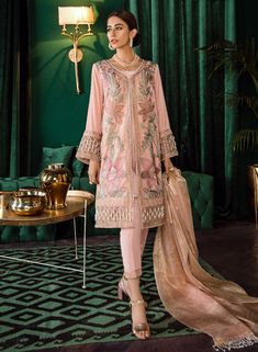 Latest embroidered velvet party outfit with chiffon dupatta is added to stores to adorn your wardrobe with party/wedding wear collection. Shirt: This lavish party wear dress is highlighting its grace with soft embroidered shirt. Velvet shirt is embellished with multi color embroidered work all over. White pearl work at sleeves border and daman border is giving elegant finishing touch to shirt. Trouser: This rich velvet embroidered velvet party outfit is paired with dyed raw silk trouser which is Lurex Top, Miroslava Duma, Pakistani Designer Suits, Salwar Kamiz, Eid Dresses, Velvet Collection, Kendall Jenner Outfits, Pakistani Designers, Shalwar Kameez