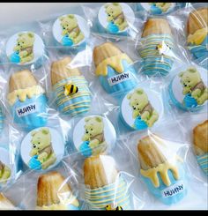 there are many cupcakes wrapped in plastic and have winnie the pooh on them