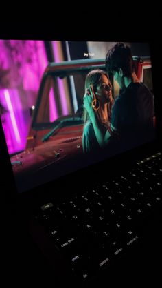 a laptop computer with a screen showing a scene from the movie love is blindfolded