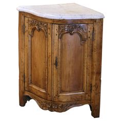 an old wooden cabinet with marble top