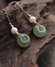 14K gold filled hetian jade donuts freshwater pearl clip-on long dangle earring. Comfortable Non pierced ear clip. gift for her Don't miss out on this timeless classic! The earring feature freshwater pearls and donuts shaped hetian jade in a clip on /ear stud design. The perfect comfortable design daily dressing. Styling tip: Perfect for everyday styling or special occasions. Product details: Sold as a pair. Materials: 14K gold filled Earring length: approx 6.5cm Hetian jade size: approx 1.0*0.5 Elegant Jade Round Beads Jewelry, Elegant Jade Jewelry With Round Beads, Elegant Jade Beaded Jewelry, Gold Plated Clip-on Jewelry Gift, Jade Jewelry With Natural Stones In Dangle Shape, Yellow Gold Jade Drop Earrings, Minimalist Clip-on Jewelry As A Gift, Single Earring With Round Beads As Gift, Round Clip-on Jewelry As Gift