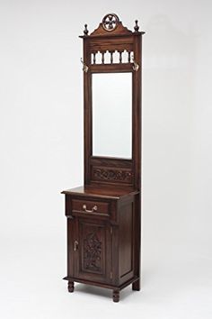 an antique wooden vanity with mirror and cabinet in the shape of a clock on it's side