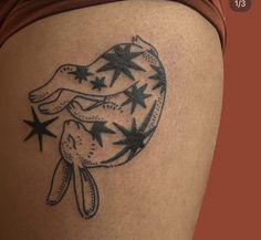 a woman's thigh with stars on it and a dog in the middle of her leg