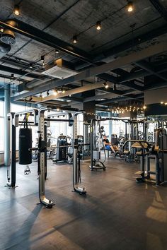 an empty gym with lots of exercise equipment