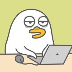 a cartoon penguin sitting in front of a laptop