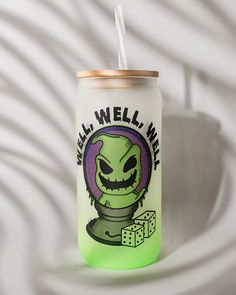 a can with a straw in it sitting on top of a white table next to a wall