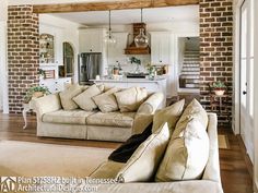 a living room filled with furniture next to a kitchen and an open concept floor plan