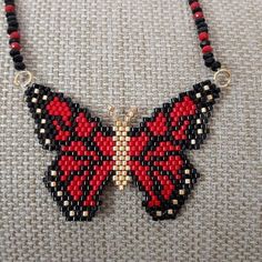 a red and black beaded butterfly necklace