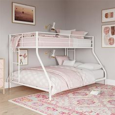 a white bunk bed sitting on top of a pink rug