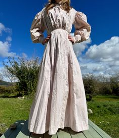 Antique country calico shirtwaist blouse and skirt late 1890s/1900  Made from a pretty cotton fabric printed with tiny pink flowers.  Blouse has very full sleeves with pleating, gathered back and a tie waist.  There are no fastenings apart from the tie waist. Slender shirt cuffs with no fastenings.  There are some small holes front waist on both sides that have been backed with  cotton panels at some point. These are somewhat concealed when the blouse is tucked into skirt.  Skirt fastens with 2 hook eyes, there is a hole near one of the hooks. If both hooks are fastened it's a 24" Waist however it can also be a 25"  In good wearable antique condition, Please see photos.  Blouse -  Chest approx 36" Across Waist 26-28" tied at front Approx 40" across hip untied Across back 15.5" Sleeve 24" C Spring Cotton Prairie Dress For Gatherings, Cottagecore Victorian Dress With Long Sleeves, Cotton Long Sleeve Victorian Cottagecore Dress, Cotton Victorian Dress With Long Sleeves In Cottagecore Style, Long Sleeve Cotton Victorian Dress For Fall, Cotton Victorian Long Sleeve Dress For Fall, Elegant Cotton Victorian Dress For Spring, Fall Victorian Long Sleeve Cotton Dress, Cotton Victorian Dress With Buttons For Daywear