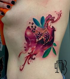 a close up of a woman's stomach with a flower tattoo on her side