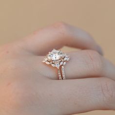 a woman's hand holding an engagement ring