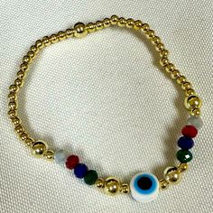 Evil Eye Elastic Bracelet With Colorful Crystal And Gold Filled Balls Brand New Adult Size Center Evil Eye Gold Filled Balls On Each Side Of Evil Eye Casual Gold Beaded Bracelets For Party, Multicolor Beaded Bracelet With Evil Eye, Casual Gold Stretch Bracelet With Colorful Beads, Casual Gold Bracelets With Colorful Beads, Trendy Gold Crystal Bracelet With Colorful Beads, Casual Handmade Gold Crystal Bracelet, Rainbow Casual Jewelry For Party, Casual Rainbow Jewelry For Party, Boho Bangle Bracelets