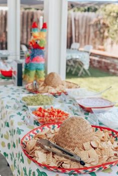 a table topped with plates and bowls filled with food