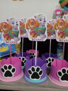 paw patrol cupcake toppers are on display at a birthday party for children in pink, purple and blue