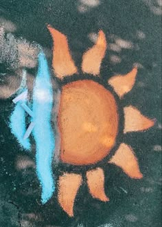 an image of a sun painted on the ground with chalk pastel and crayons