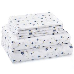 four sheets stacked on top of each other in blue and white floral print, with one folded