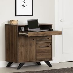 a laptop computer sitting on top of a wooden desk next to a white door in a room