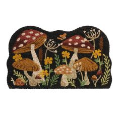 a black rug with mushrooms and flowers on the front, along with butterflies in the background