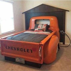 an orange truck bed in a room with two windows