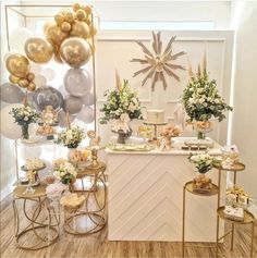 a dessert table with balloons and flowers on it