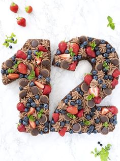 the letter s is made up of chocolate, strawberries, and chocolate cake slices