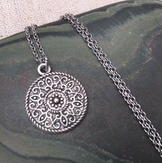 This is a understated and elegant little boho disc pendant necklace.  It is perfect for everyday wear and would go with just about anything.  The disc measures 3/4” long by 5/8” wide and is made from allergy free plated silver.  It hangs from a simple stainless steel necklace chain.I have matching earrings in my shop, if you would like the whole set.  Here is the link.......... https://etsy.me/2VZ551y Thanks for stopping by!  Please take a moment and visit the rest of my Etsy shop.    I have man Hunting Jewelry, Dainty Jewelry Necklace, Silver Necklace Simple, Designer Handmade Jewellery, Handmade Jewelry Gift, Bohemian Necklace, Disc Necklace, Unique Jewelry Designs, Simple Necklace