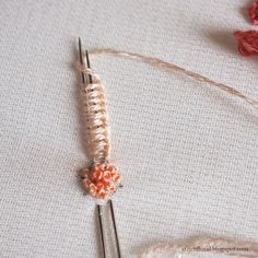 a close up of two knitting needles and some yarn