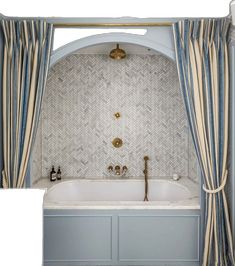 a bath tub sitting under a window next to a curtained shower stall with two faucets