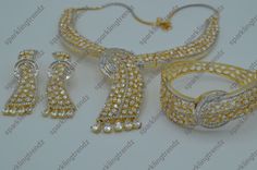 A Premium high quality gold finish designer CZ with Baguette Diamond necklace set with bracelet. Finish: Gold Bracelet should fit size 2.4,2.6 & 2.8. Suitable for all Occasions. Availability: In-Stock *Color may vary slightly due to light condition & photography. Jewelry Care: Keep away from moisture. Allow perfumes and lotion to dry before wearing. Store in jewelry pouch. Clean only with soft lint free cloth. Luxury American Diamond Jewelry Sets For Party, Elegant Sparkling Jewelry For Festive Occasions, Elegant Sparkling Festive Jewelry, Elegant Festive Sparkling Jewelry, Luxury Jewelry Sets With Sparkling Stones, Party Jewelry Sets With American Diamond And Round Shape, Luxury American Diamond Round Jewelry Sets, Luxury Party Jewelry Sets, Glamorous Diamond Jewelry Sets For Gifts