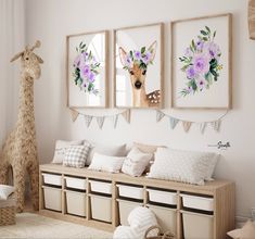 a room filled with furniture and pictures on the wall next to a stuffed giraffe