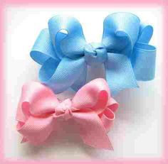 three different colors of bows on a white background with pink, blue and light pink