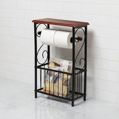 a toilet paper holder with two rolls of toilet paper on it and a magazine rack