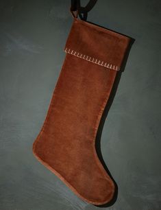 a brown suede stocking hanging on a wall