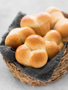 a basket filled with rolls sitting on top of a table