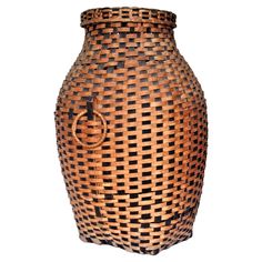 a large woven basket is shown on a white background, with the lid open to reveal an interesting design