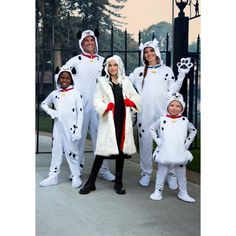 a group of people dressed in costumes posing for a photo with one woman and two children