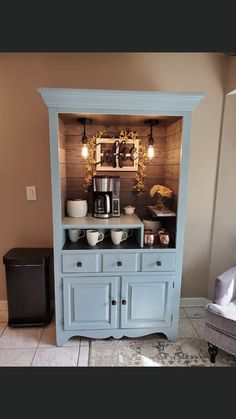 a blue china cabinet in the corner of a living room