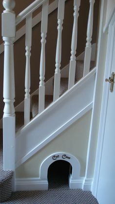 a dog house under the stairs with its door open