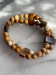 Beaded Double Strand Unisex Bracelet .  This beautiful style is made from Pictural Jasper Stones, Size 7.5-8..(there is a matching "Thumb Huggr" Ring avail in a separate listing)  Designed by MAA Custom Made Brand.  The last photo shows how you might group your bracelets with others we are offering to pull your look together.  I hope you'll enjoy it for a lifetime ❤️ Casual Brown Bracelets With Gemstone Beads, Casual Brown Gemstone Beads Bracelets, Bohemian Brown Stretch Bracelet For Meditation, Casual Brown Stretch Bracelet For Healing, Casual Brown Beaded Bracelets With Gemstone Beads, Casual Brown Beaded Bracelets With Gemstones, Handmade Earthy Brown Stretch Bracelet, Rustic Hand-strung Brown Bracelets, Rustic Brown Hand-strung Bracelets